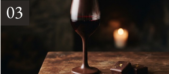 Chocolate wine glass concept with a lit candle